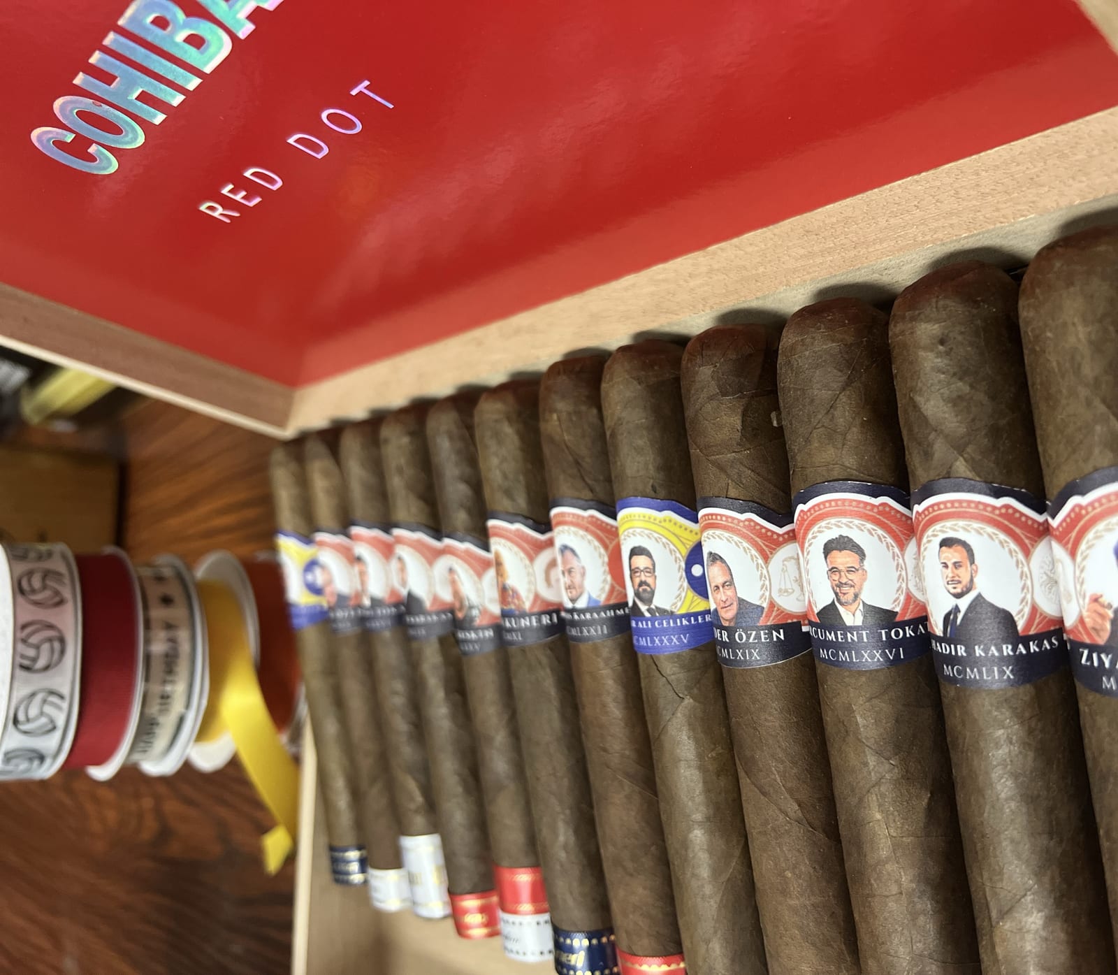 Custom-banded celebration cigars arranged with a ribbon for a milestone night