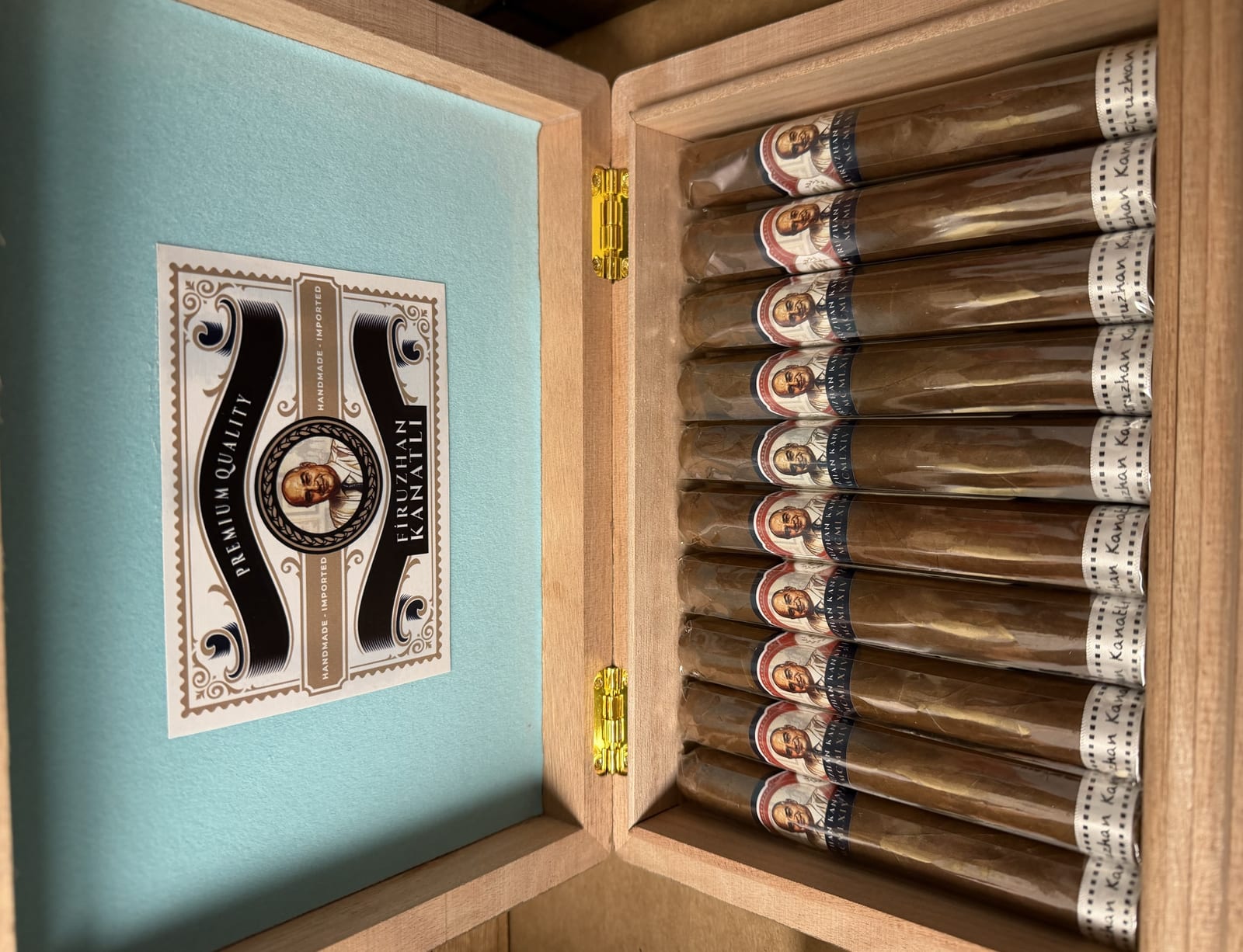Open cedar box of custom wedding favor cigars with personalized name-and-date bands